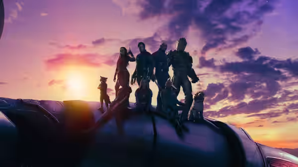 the team standing atop their vessel under a glowing sunset sky