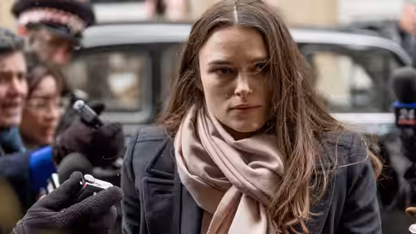 Katharine Gun (Keira Knightley) facing microphones and cameras outside