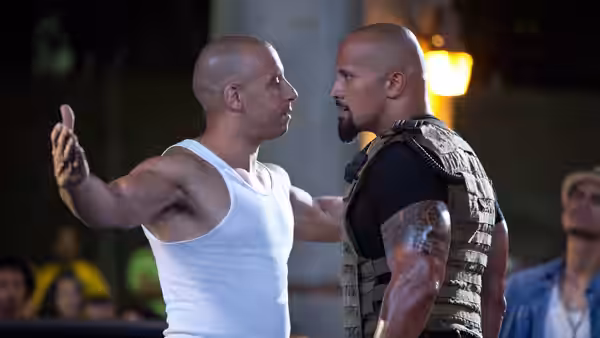 Dominic Toretto (Vin Diesel) greets Luke Hobbs (Dwayne Johnson) on a crowded street