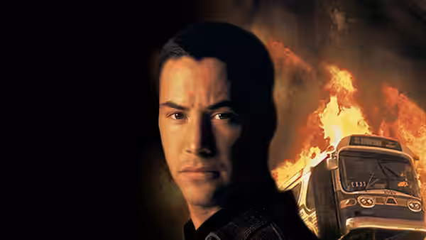 Jack Traven (Keanu Reeves) with a burning bus in the background