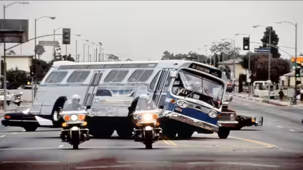 A city bus swerving through traffic with motorcycles alongside
