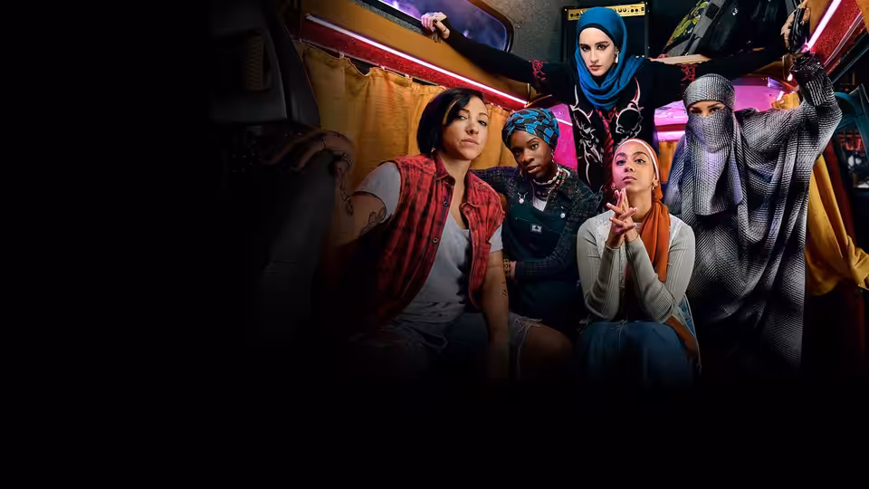 Five women in headscarves posing together inside a neon-lit vehicle