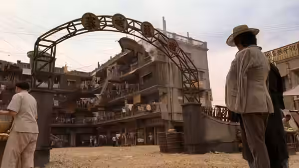 A hat-wearing man watches the crowded Pig Sty Alley courtyard from beneath an arch