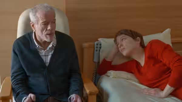 Georg (Pascal Greggory) sits beside Sandra (Léa Seydoux) in a hospital bed