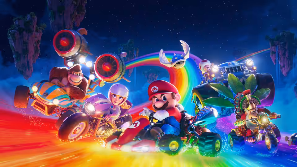 Mario leading a pack of racers in karts along a glowing rainbow track
