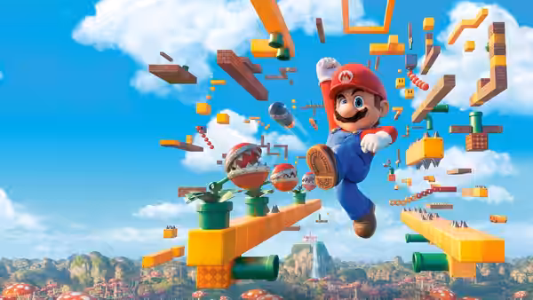 Mario leaping through floating blocks and enemies in a bright blue sky