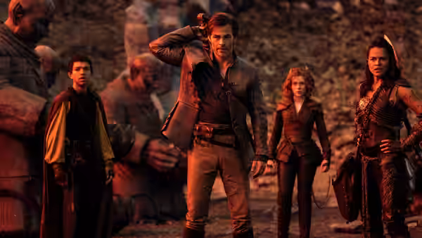 Edgin (Chris Pine) stands with his hand raised among companions outdoors