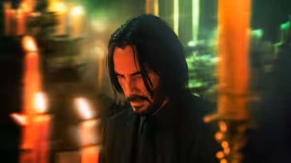 John Wick (Keanu Reeves) looking down amid glowing candles