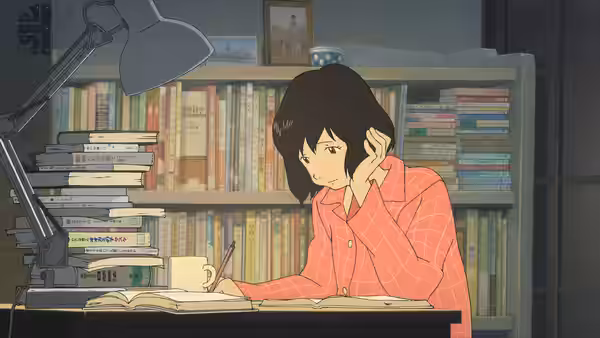 A young woman studying at a desk surrounded by stacks of books