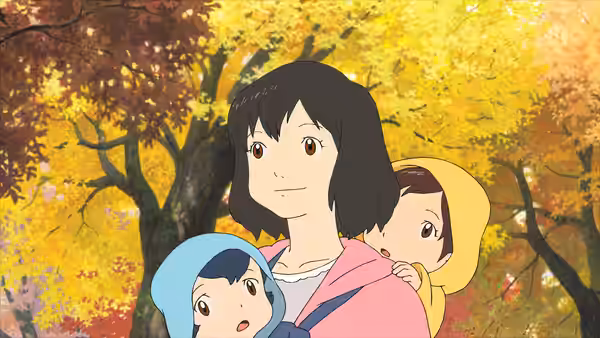 A woman carrying two children through an autumn forest with colorful trees
