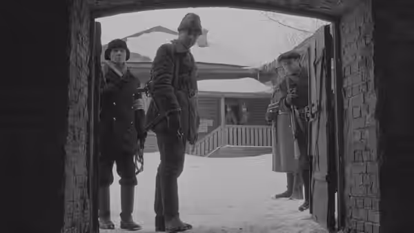 Armed men stand in a snowy village doorway facing a group outside