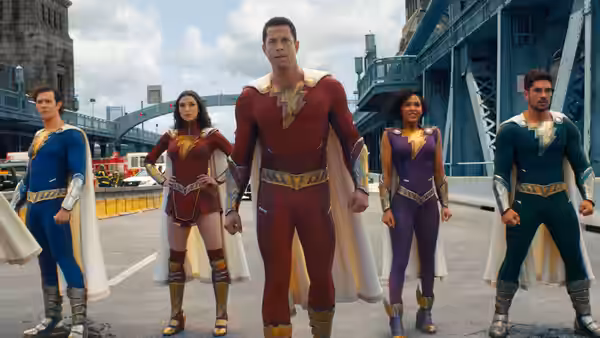 Shazam (Zachary Levi) stands with four superheroes on a city bridge