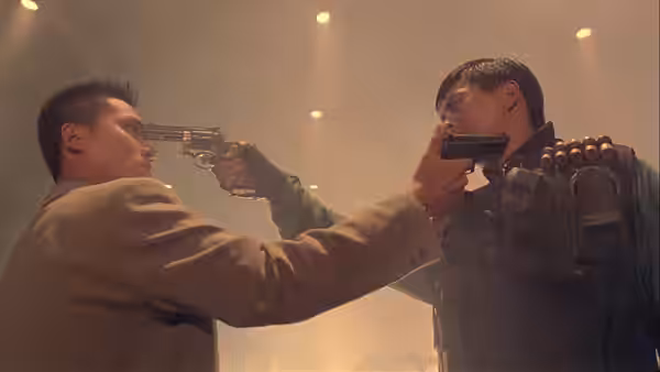 Man aiming revolver at Chow Yun-Fat's head as he points pistol back
