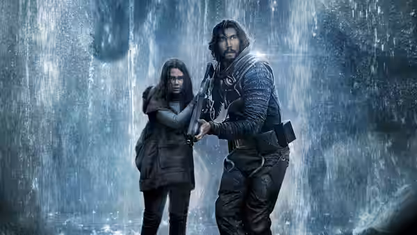 Mills (Adam Driver) and Koa (Ariana Greenblatt) stand in a cave with falling water