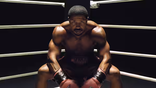 Adonis Creed (Michael B. Jordan) crouching in the boxing ring