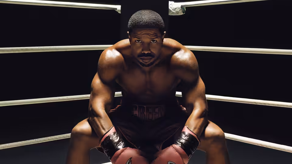 Adonis Creed (Michael B. Jordan) crouching in the boxing ring