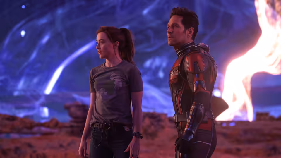 Ant-Man and a young woman standing together in a rocky alien landscape