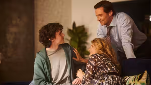 Peter (Hugh Jackman) with Nicholas (Zen McGrath) and Kate (Laura Dern) indoors on a couch