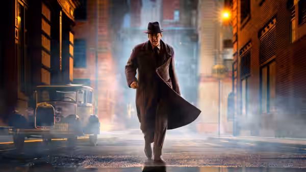 A man in a trench coat and fedora striding through a foggy street