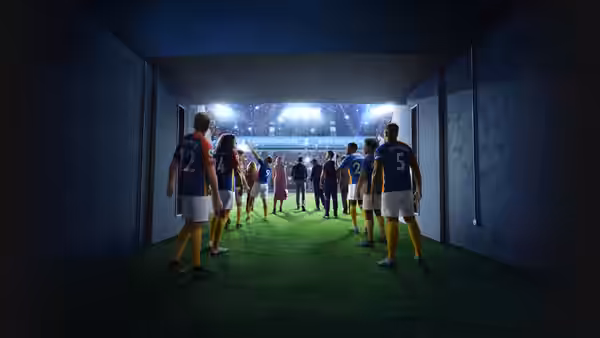 Football players in blue and yellow walking through a tunnel to the pitch