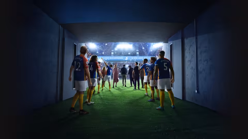 Football players in blue and yellow walking through a tunnel to the pitch
