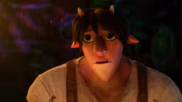 A horned, pointed-eared young man in a rough tunic looks ahead in a dim room