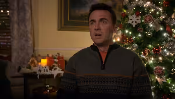 Hal (Bryan Cranston) staring ahead with wide eyes near a Christmas tree