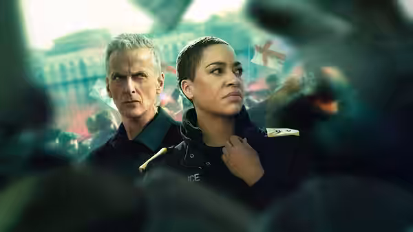 DCI Daniel Hegarty (Peter Capaldi) and DS June Lenker (Cush Jumbo) in police uniforms at a protest