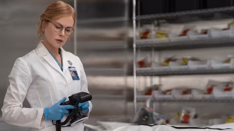 Kay Scarpetta (Nicole Kidman) inspecting a device in the evidence lab