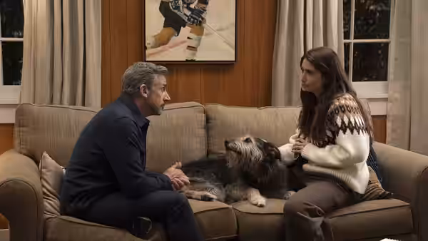 Steve Carell as Greg Russo and a woman on a couch with a dog