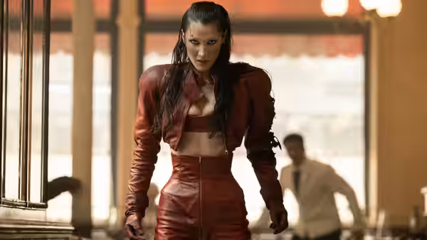 woman in red leather outfit standing in a modern building interior