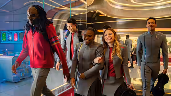 Group of cadets walking together through a sleek futuristic academy interior