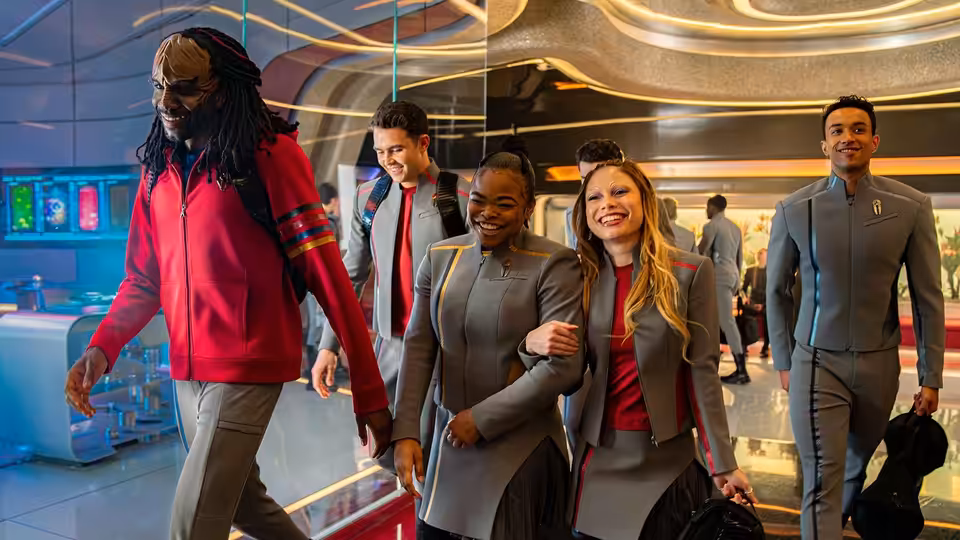 Group of cadets walking together through a sleek futuristic academy interior