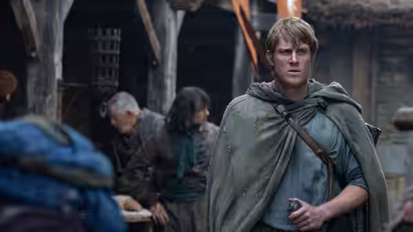 Ser Duncan the Tall (Peter Claffey) standing among villagers in a settlement