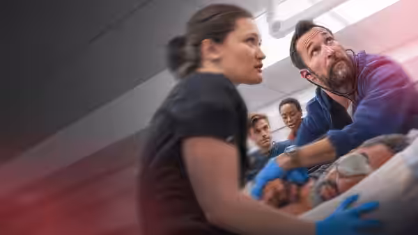 Dr. Robby (Noah Wyle) and a colleague treat a patient on a gurney