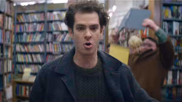Jonathan Larson (Andrew Garfield) looking surprised in a bookstore