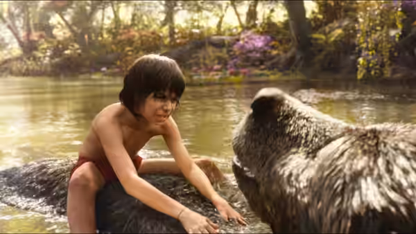 Mowgli (Neel Sethi) reaches out to Baloo in a jungle river