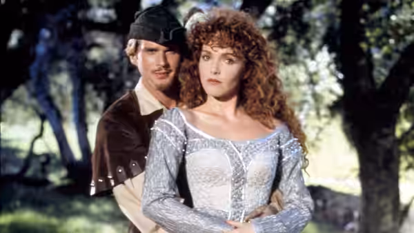 Robin Hood (Cary Elwes) holds Maid Marian (Amy Yasbeck) close outdoors