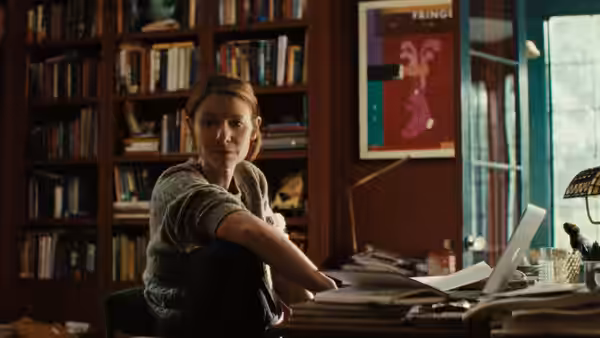 Agatha Wiggs (Claire Danes) seated in a cluttered home office