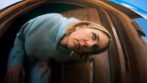 Carol Sturka (Rhea Seehorn) leaning forward and looking down from above