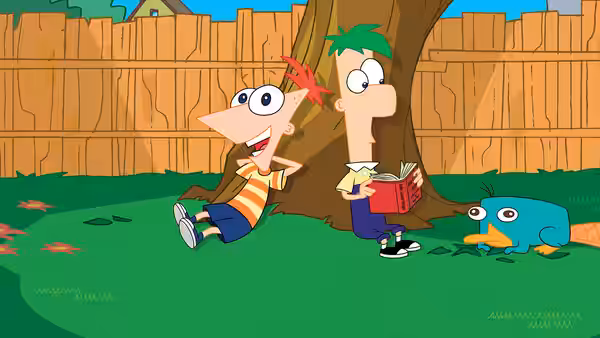 Phineas Flynn laughing beside Ferb Fletcher reading under a backyard tree with Perry