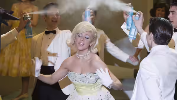 Amber Von Tussle (Brittany Snow) being sprayed with hairspray at a dance