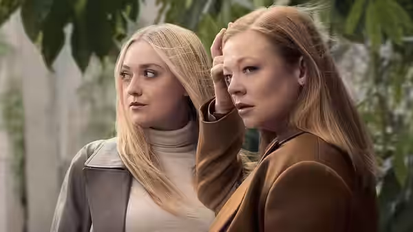 Marissa Irvine (Sarah Snook) and Jenny Kaminski (Dakota Fanning) standing close outdoors with hand on head