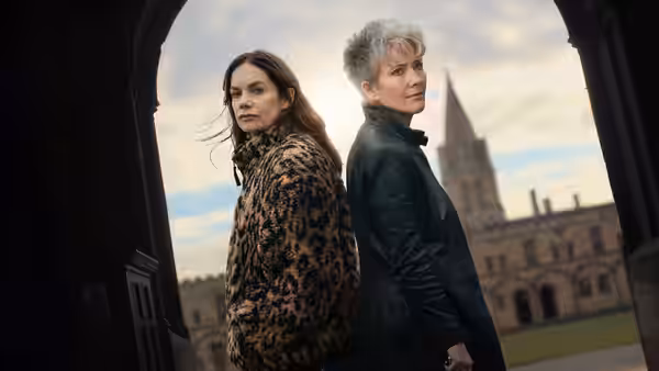 Emma Thompson as Zoë Boehm and Ruth Wilson as Sarah Trafford standing back to back under an archway