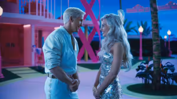 Ken and Barbie standing face to face outdoors in Barbie Land at night