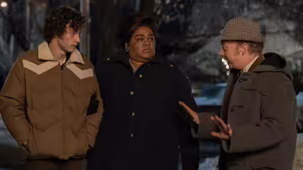 Angus Tully, Mary Lamb and Paul Hunham conversing outdoors in the snow