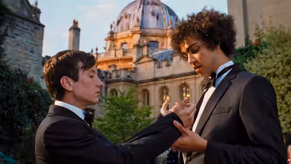 Oliver Quick (Barry Keoghan) and Farleigh Start (Archie Madekwe) in formal attire outdoors