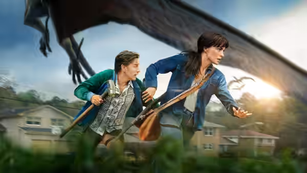 Ewan McGregor and Anne Hathaway running from a large flying creature
