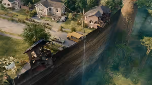 Aerial view of suburban houses divided by a massive vertical cliff