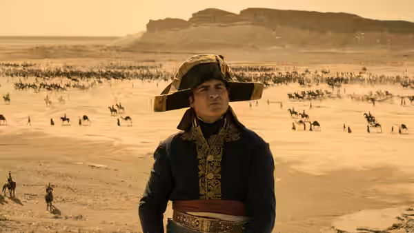 Napoleon Bonaparte (Joaquin Phoenix) standing in a desert with his army